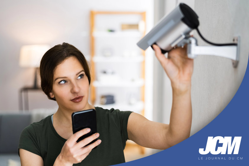 Femme qui règle sa caméra de surveillance